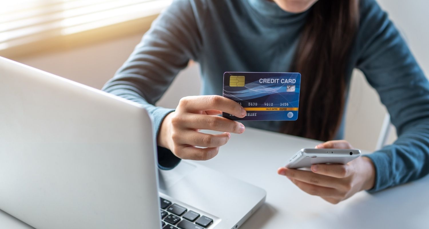 person using a credit card to purchase something online