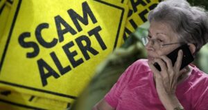 scam alert sign older woman phone
