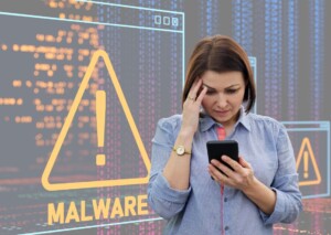 woman looking at her phone with malware