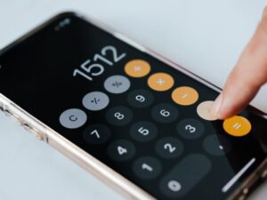 Hand on iPhone calculator