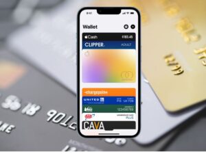 Credit cards in the background with iPhone Wallet app open