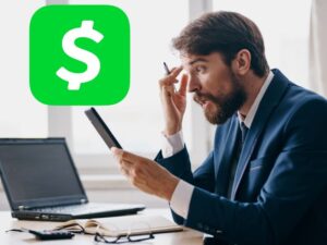 Man stressed looking at phone and cash app logo