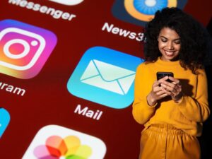 woman smiling at phone and iPhone email icon