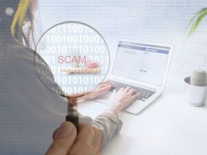 PERSON TYPING ON LAPTOP AND SCAM GRAPHIC