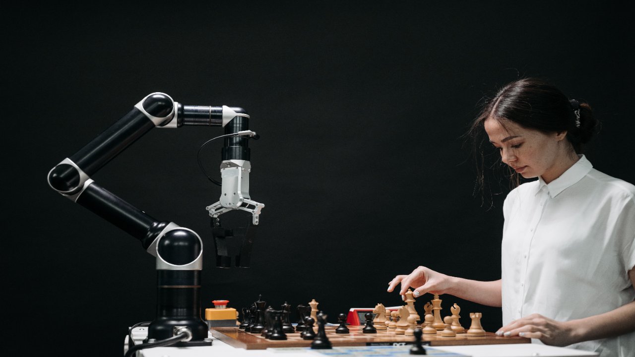 girl playing chess with robot