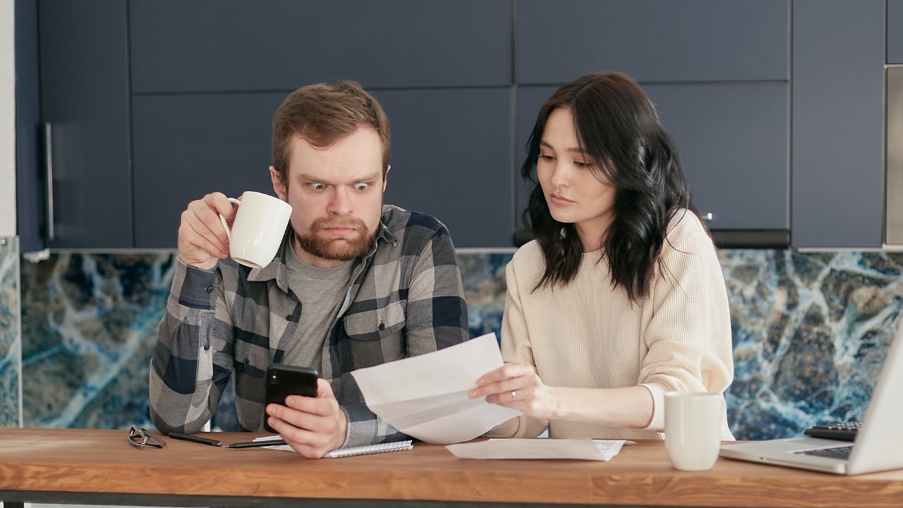 2-couple looking at invoice