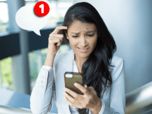 woman looking at phone confused