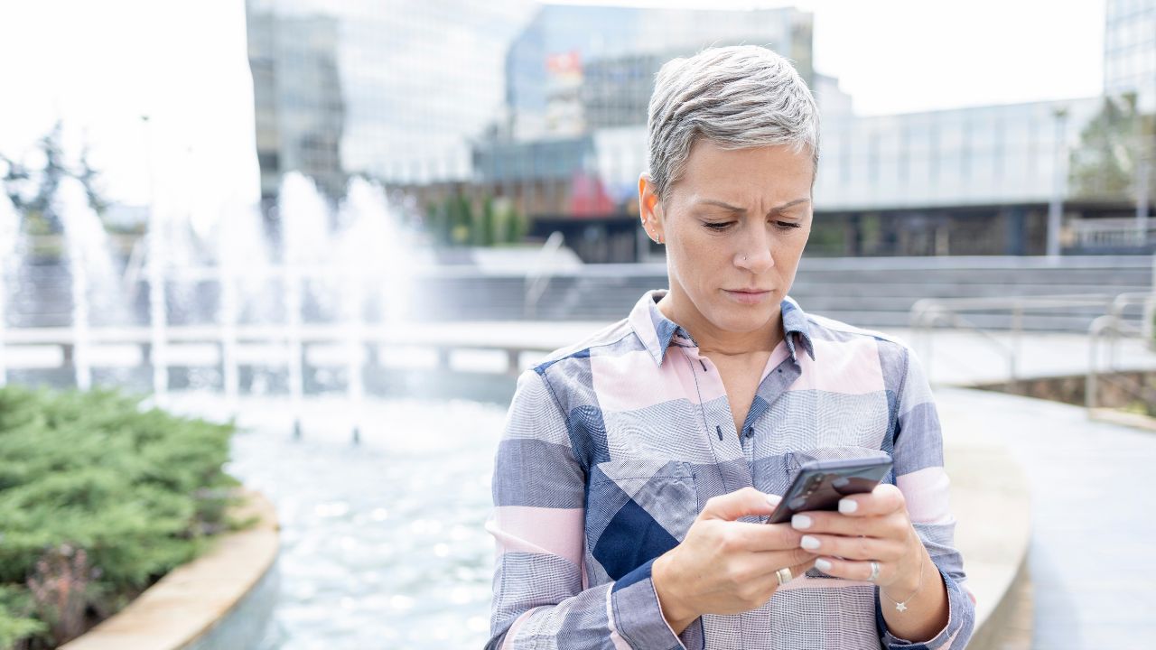 1-WOMAN LOOKING AT PHONE