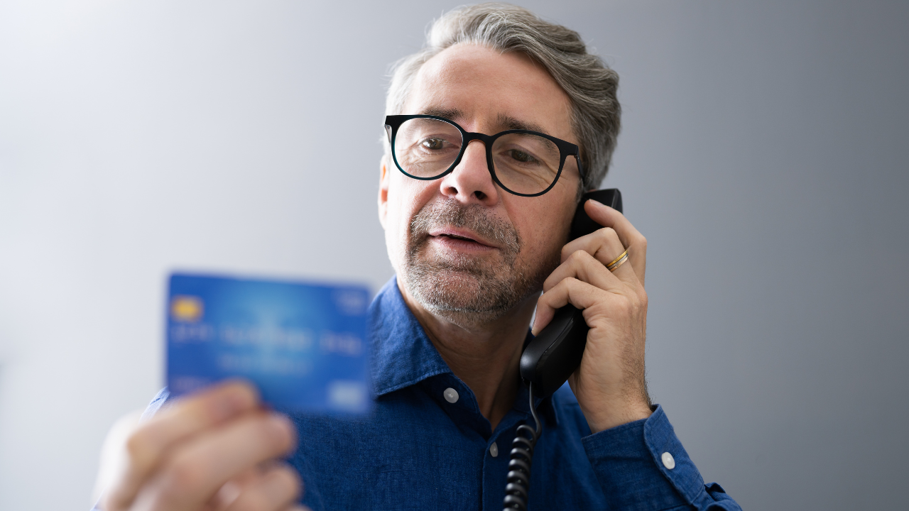 man on phone with credit card