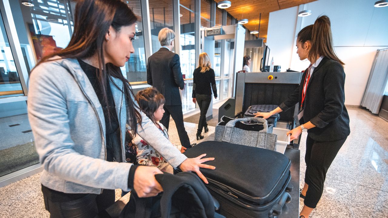 2-PEOPLE GETTING BAGS CHECKED