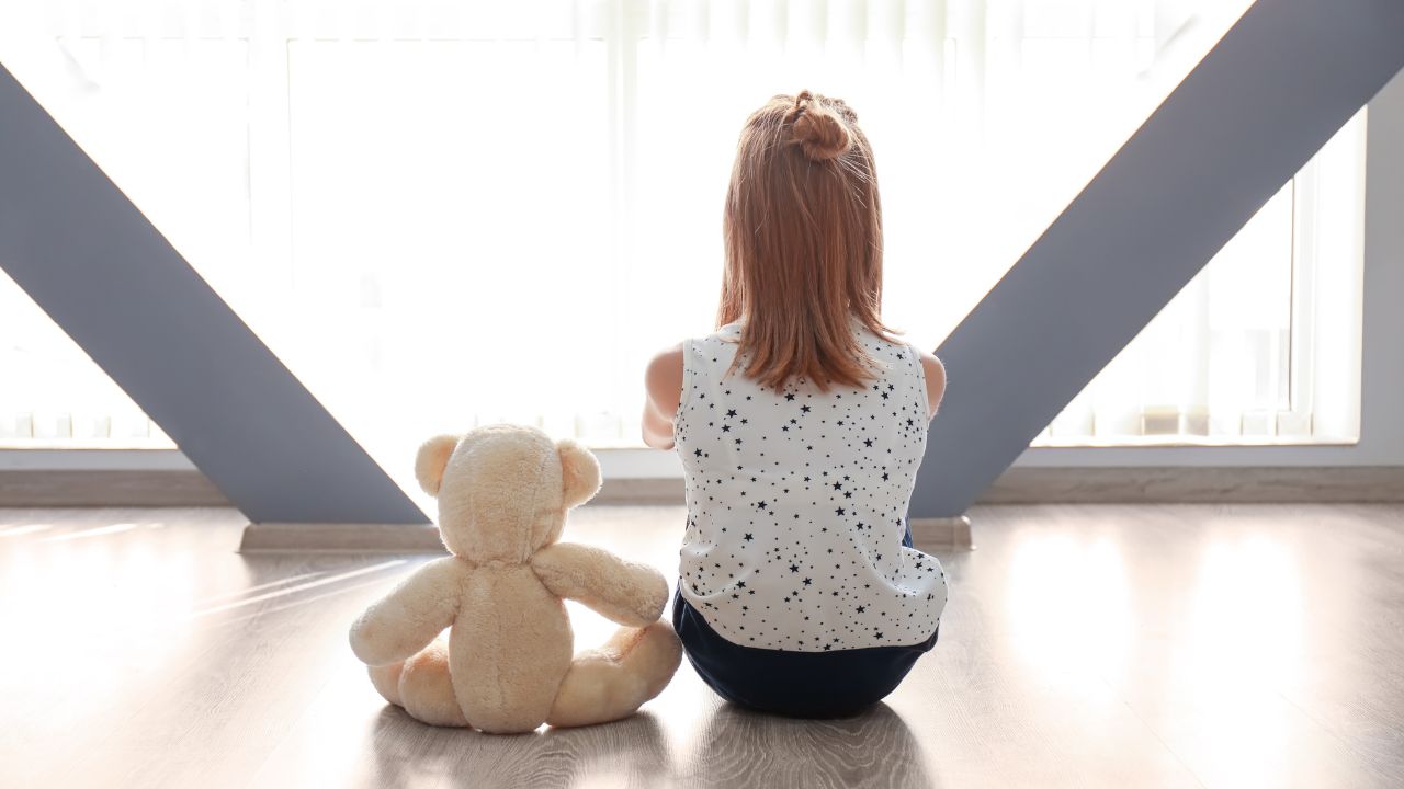 young child and a teddy bear
