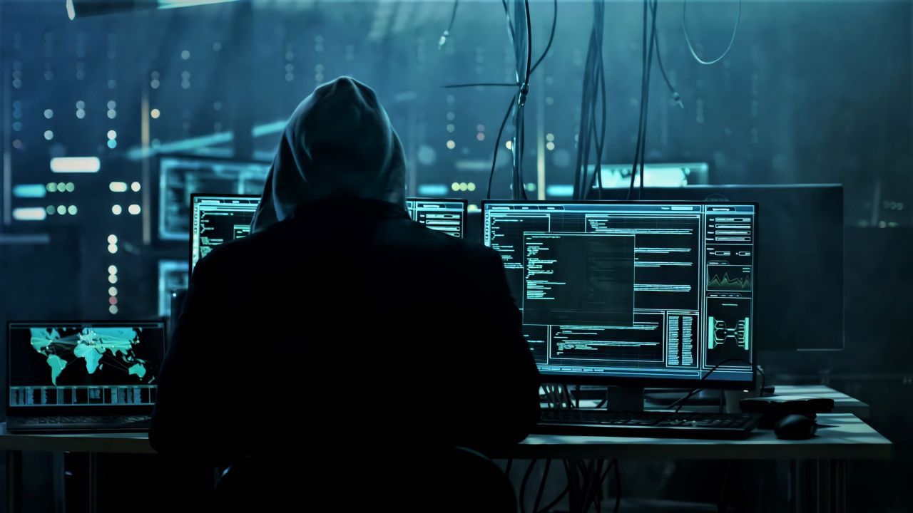 person in hoodie using a computer