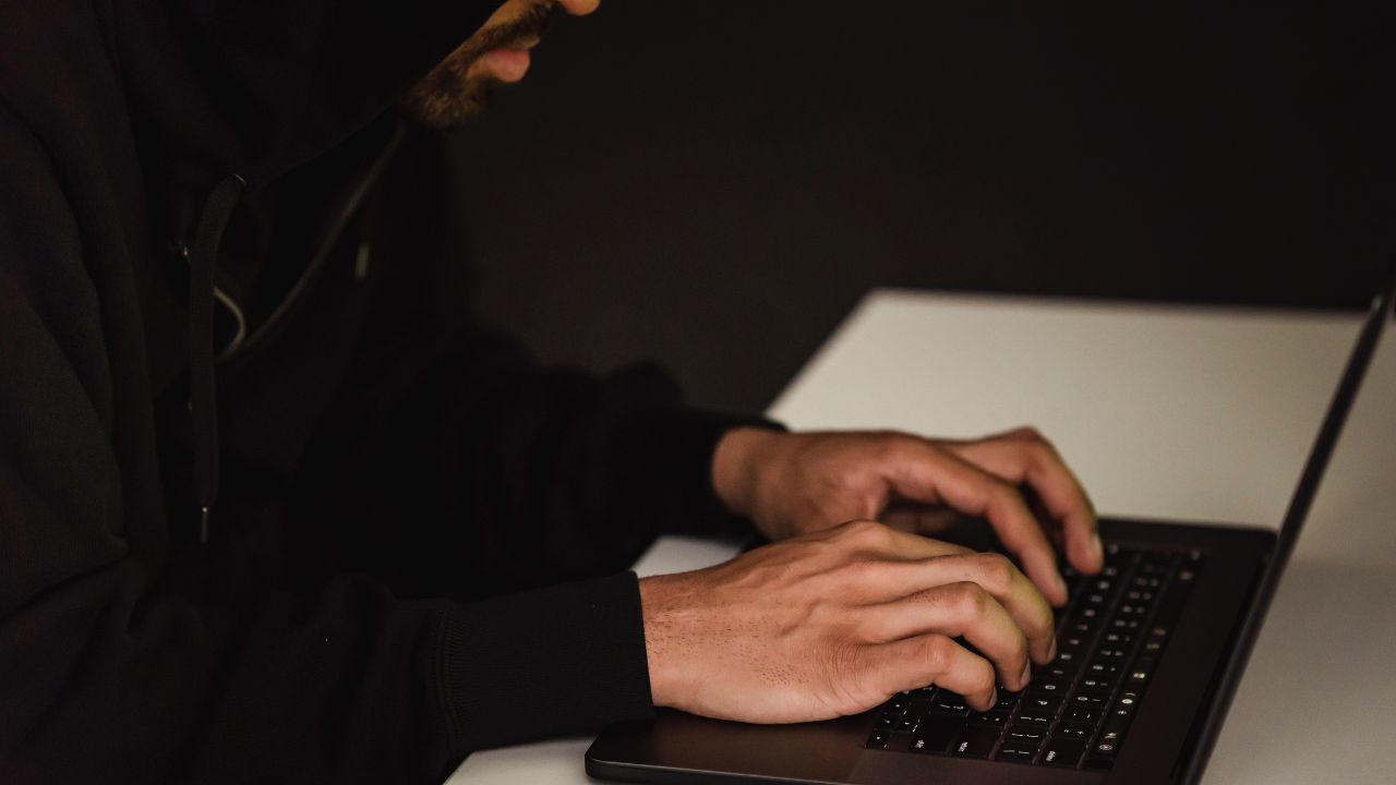 person in hoodie using computer
