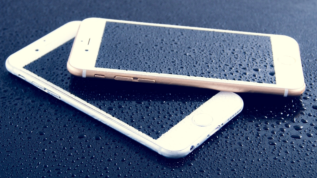 A stock image of two iPhones with water damage on them.