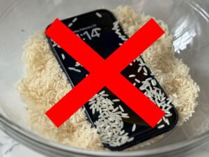 X over iPhone in a bowl of rice