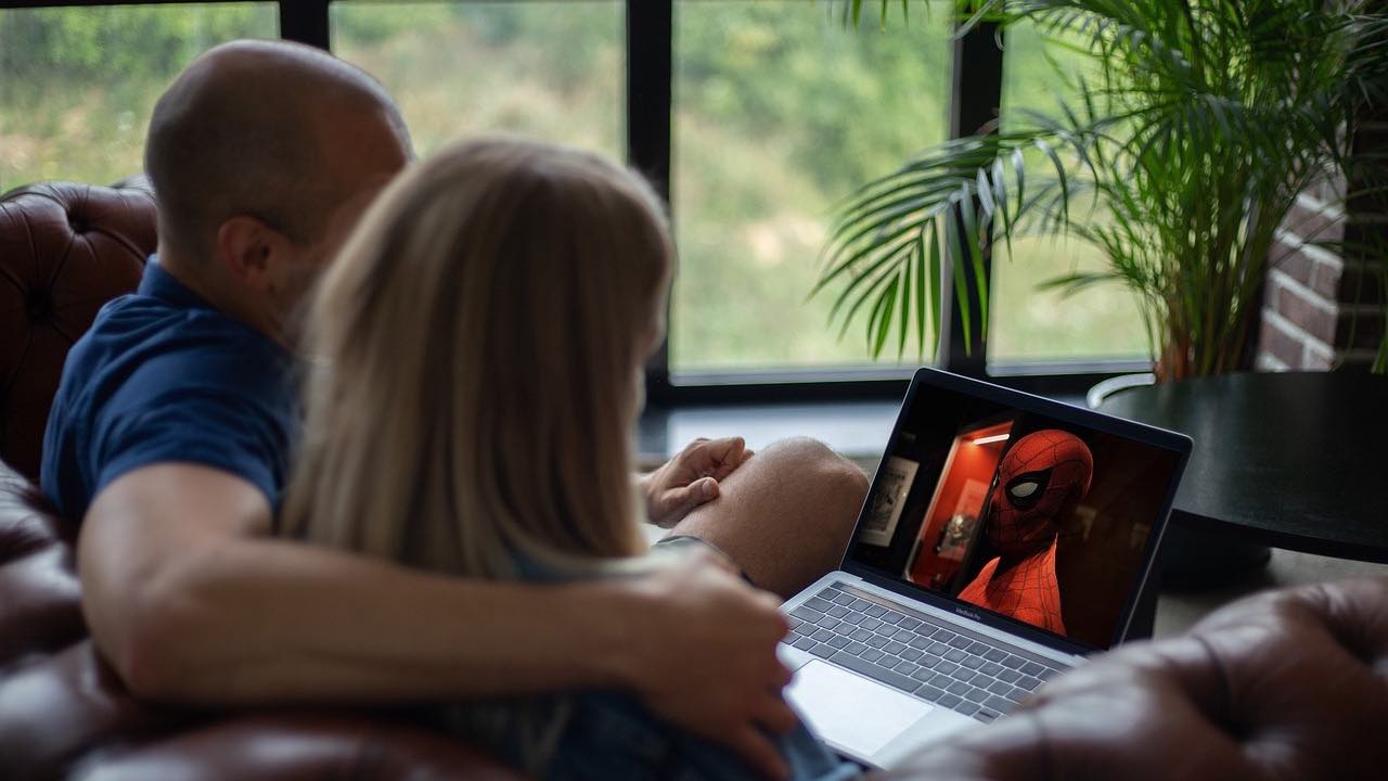 Couple streaming a movie on laptop