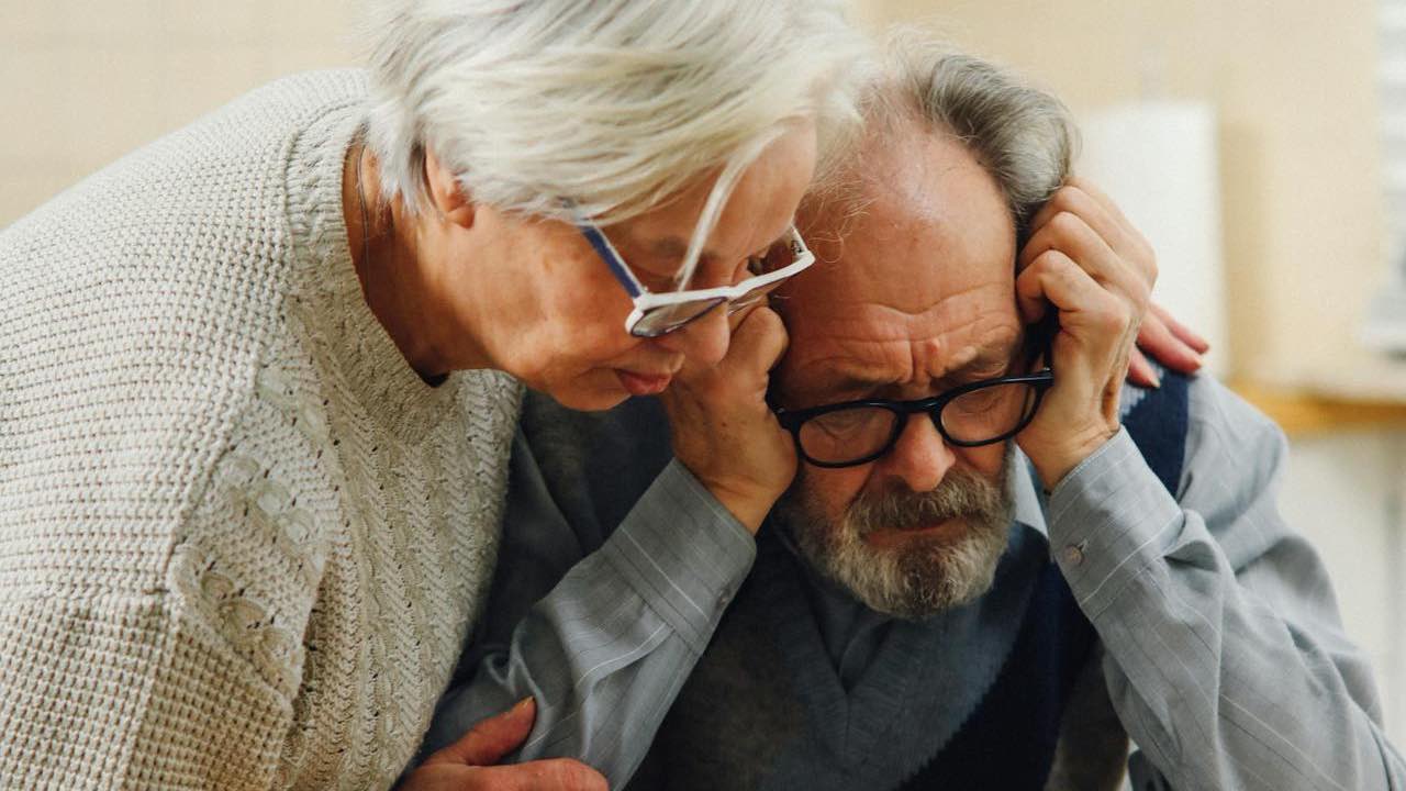 Elderly worried couple looking at documents