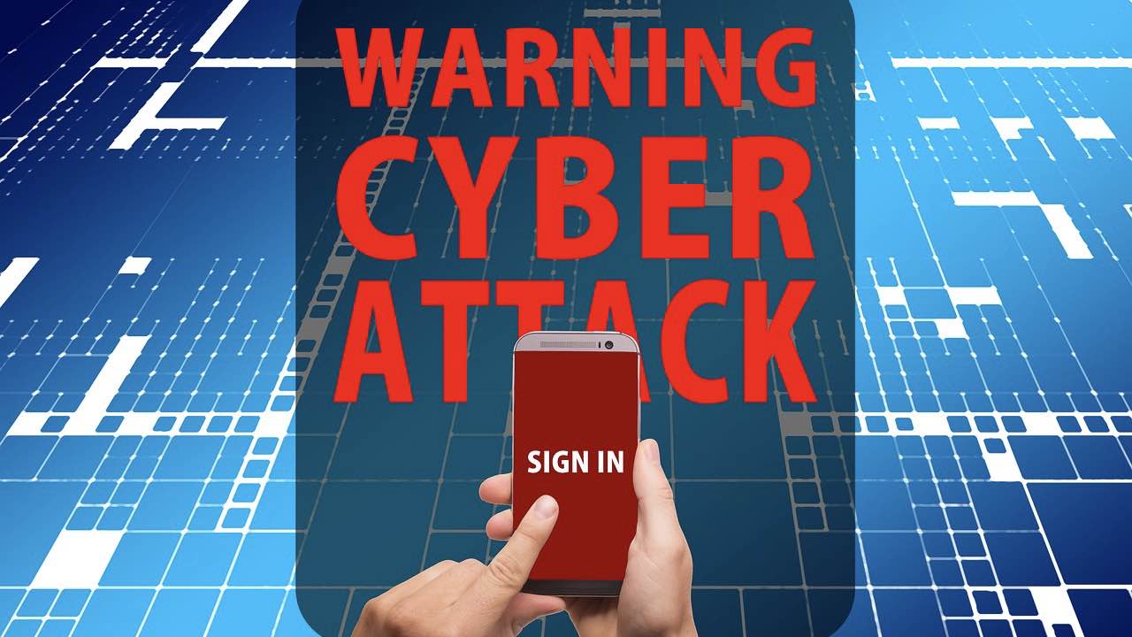 A phone in hand getting a cyberattack warning at sign in