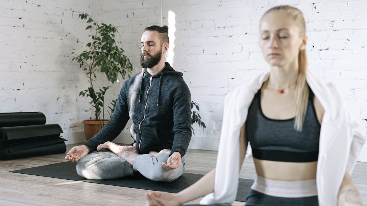 man and woman yoga class