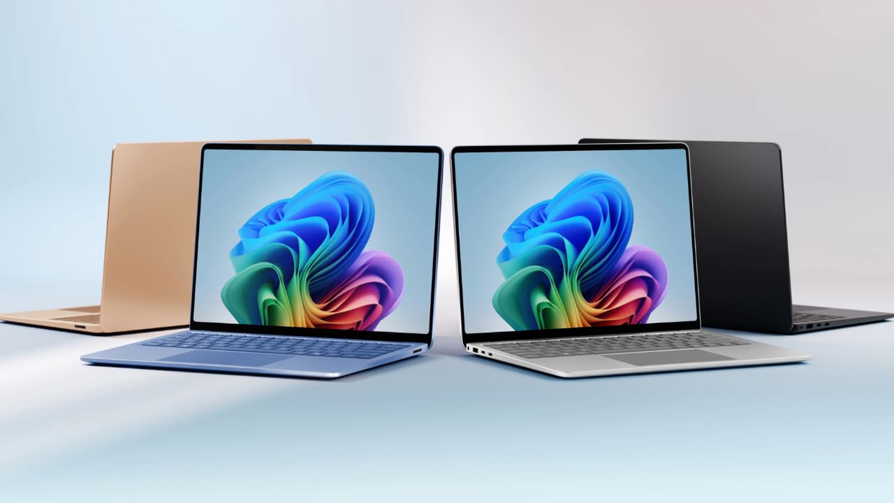 Windows laptops against a colorful background.