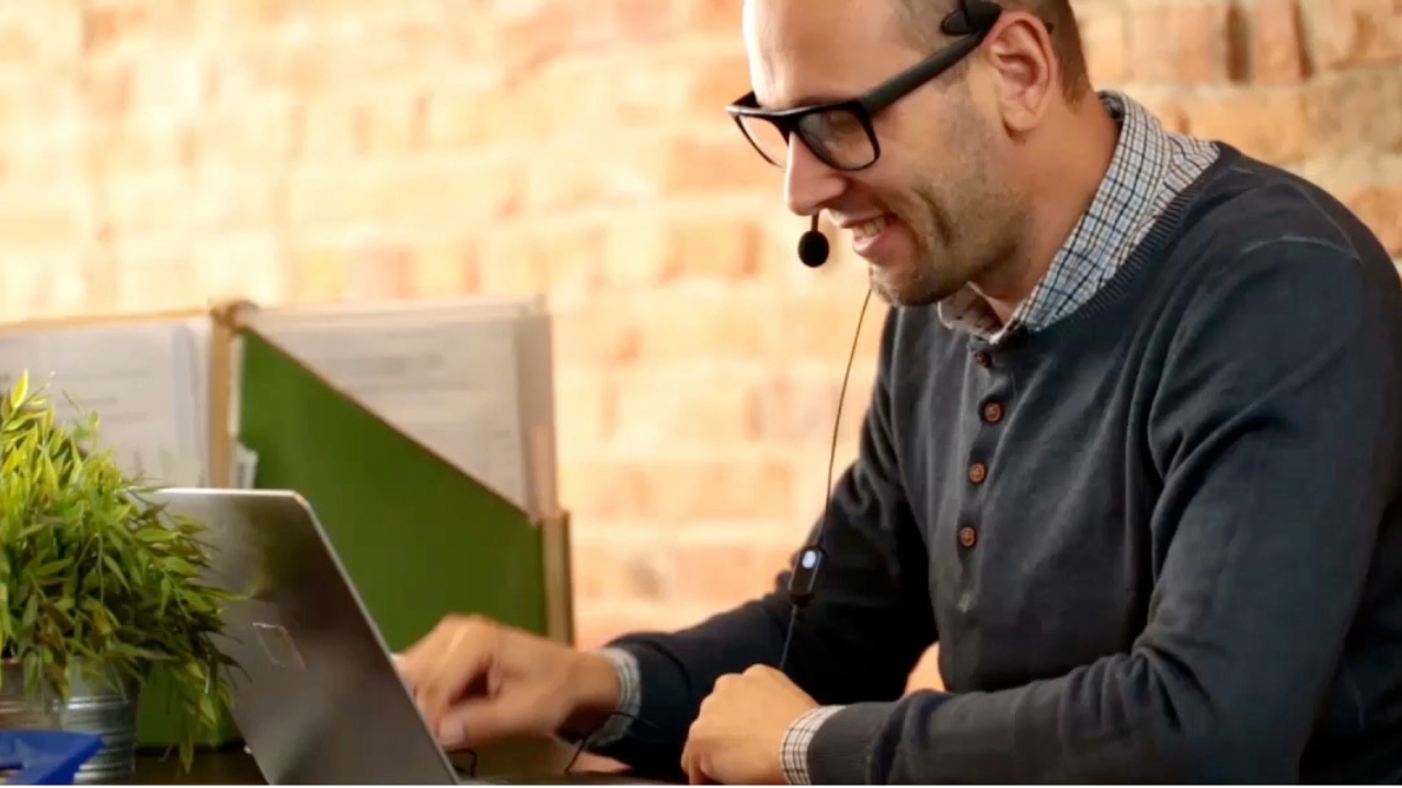 A person typing on a MacBook.