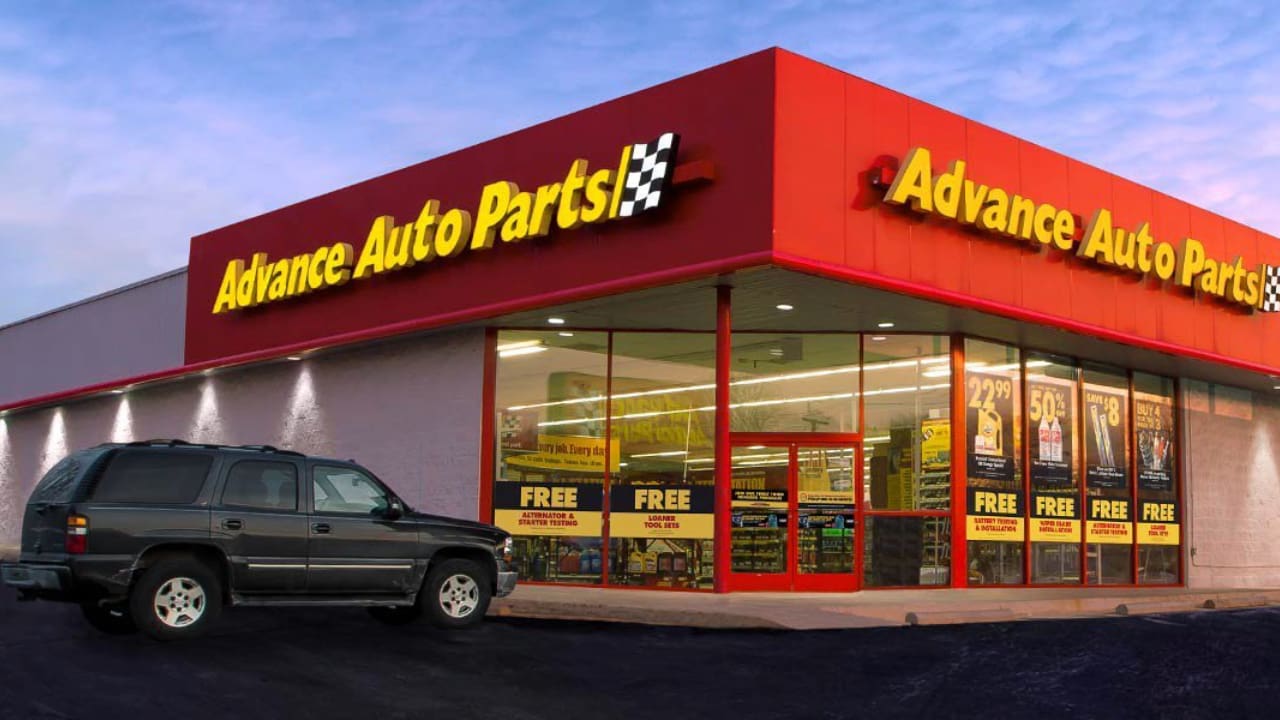 An Advance Auto Parts store with a car parked in the front.