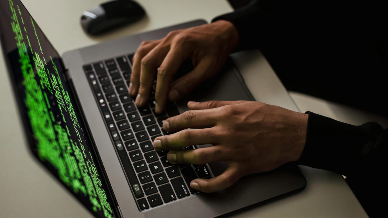 A person typing on a laptop.