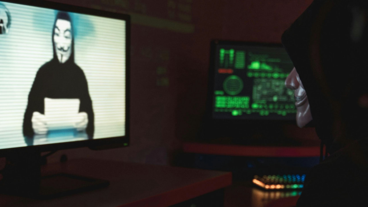 A person sitting in front of a monitor