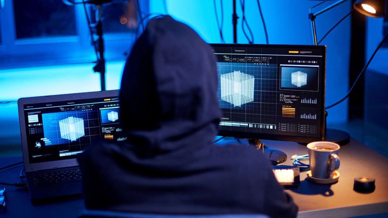 A person using computer in a dark room.