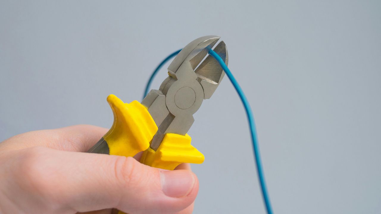 Cutting Cable with Pliers in Close Up