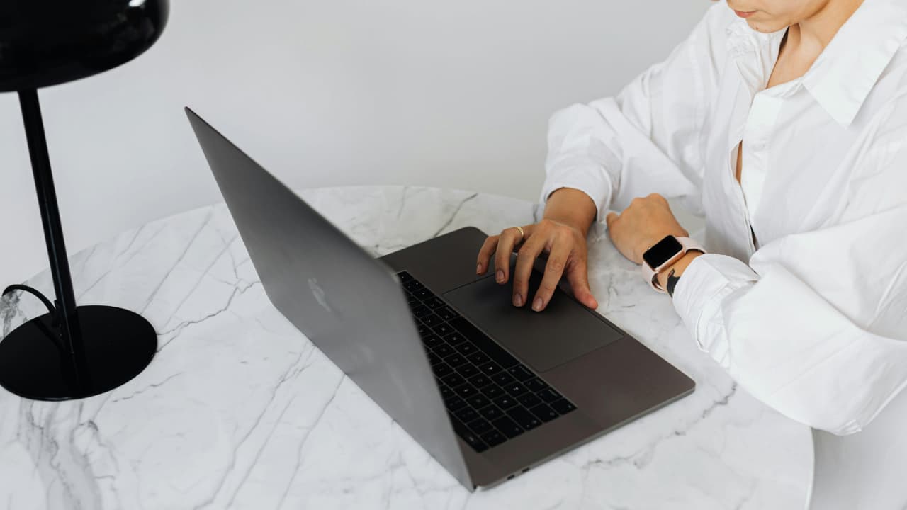 A person typing on MacBook.