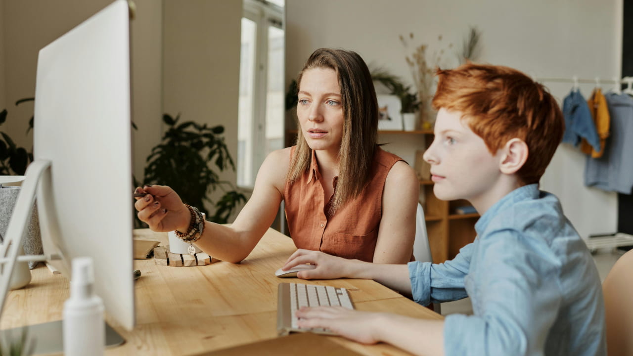 Two people looking at a computer.