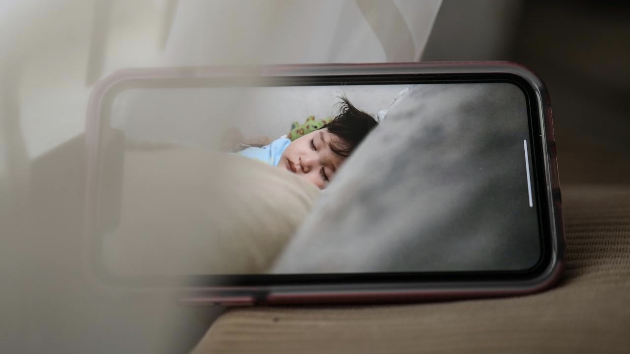 screen of mobile phone with sleeping baby