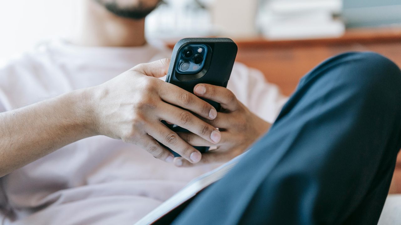 A man looking through apps on his cell 