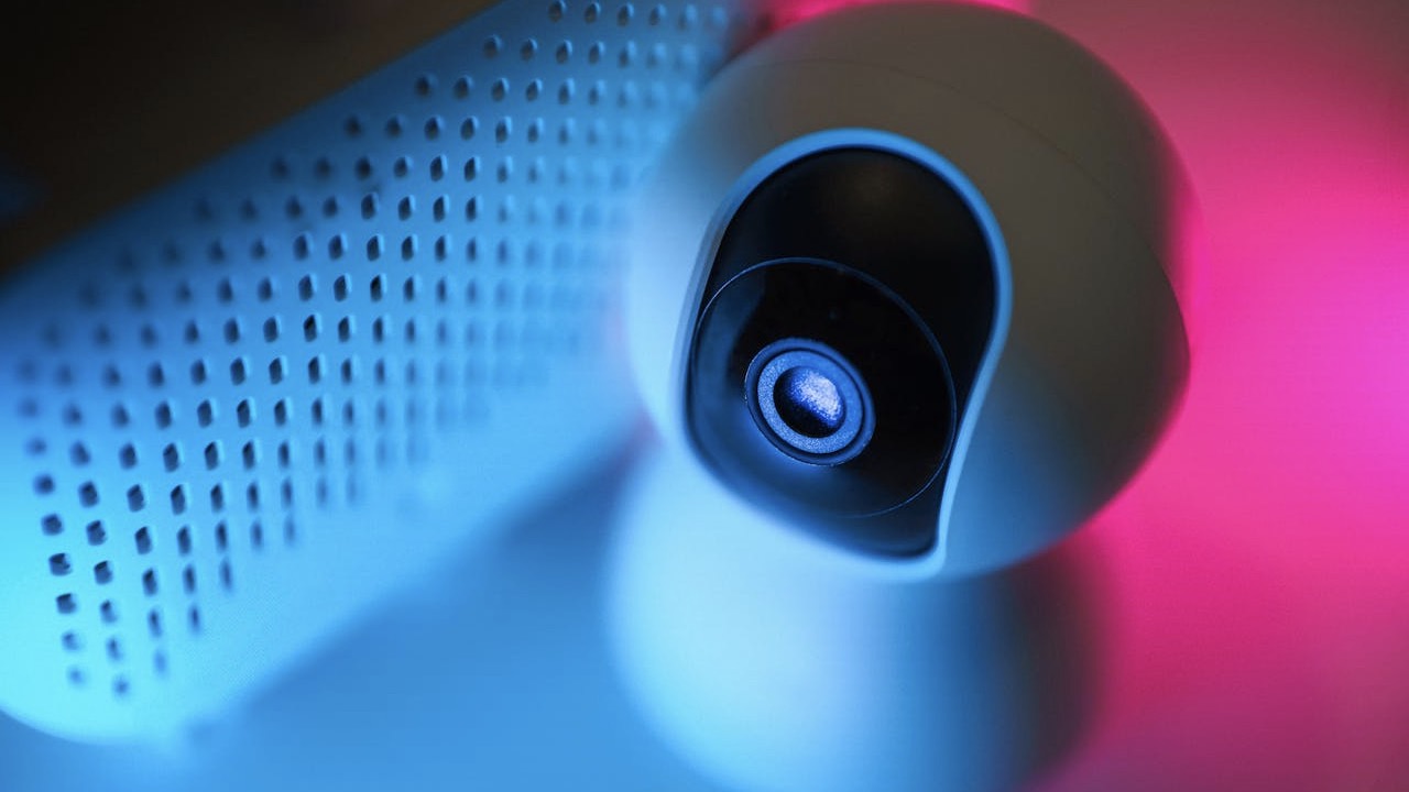 security camera by speakers in blue and pink neon light