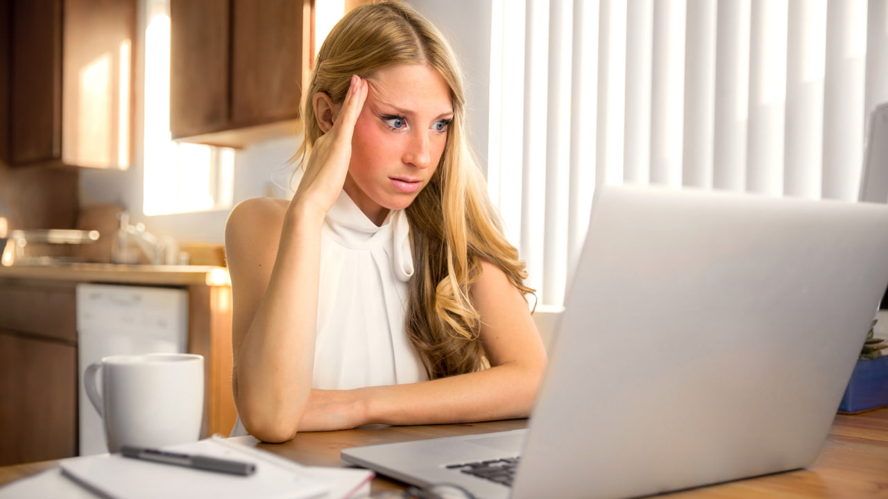 A woman using a laptop.