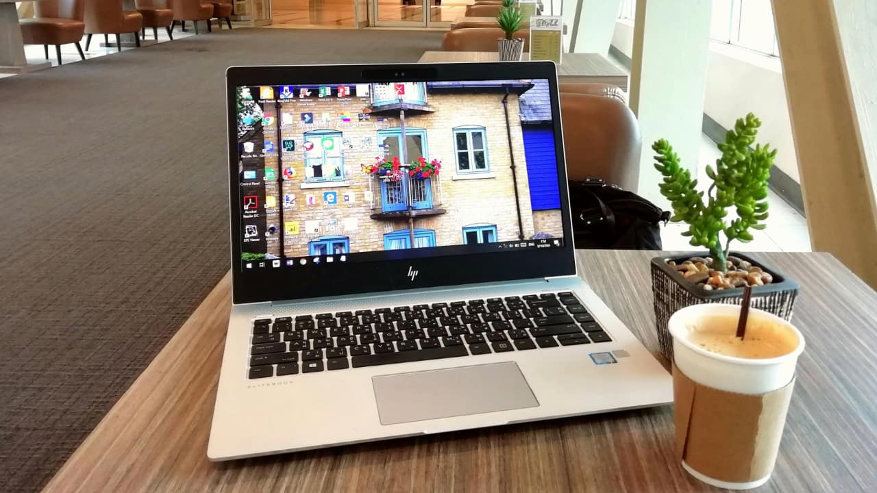 A Windows laptop kept on a wooden table.