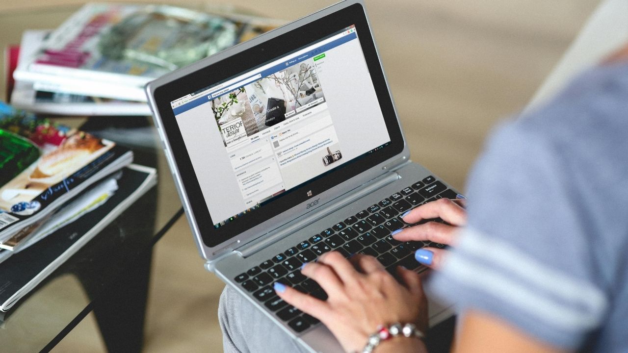 A woman scrolling on her Facebook account 