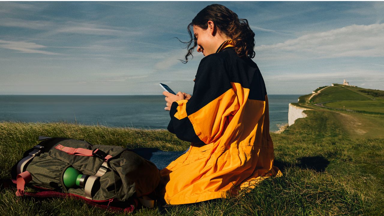 A woman scrolling on her iPhone 