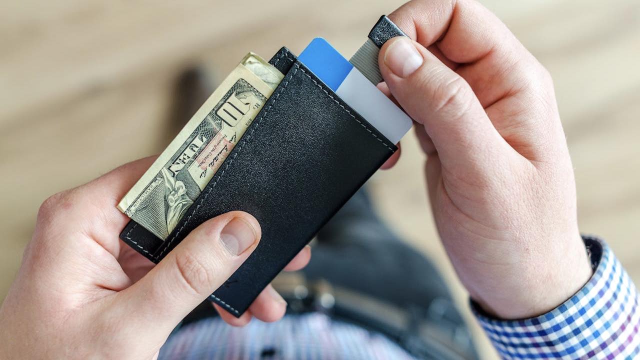 person holding black cardholder