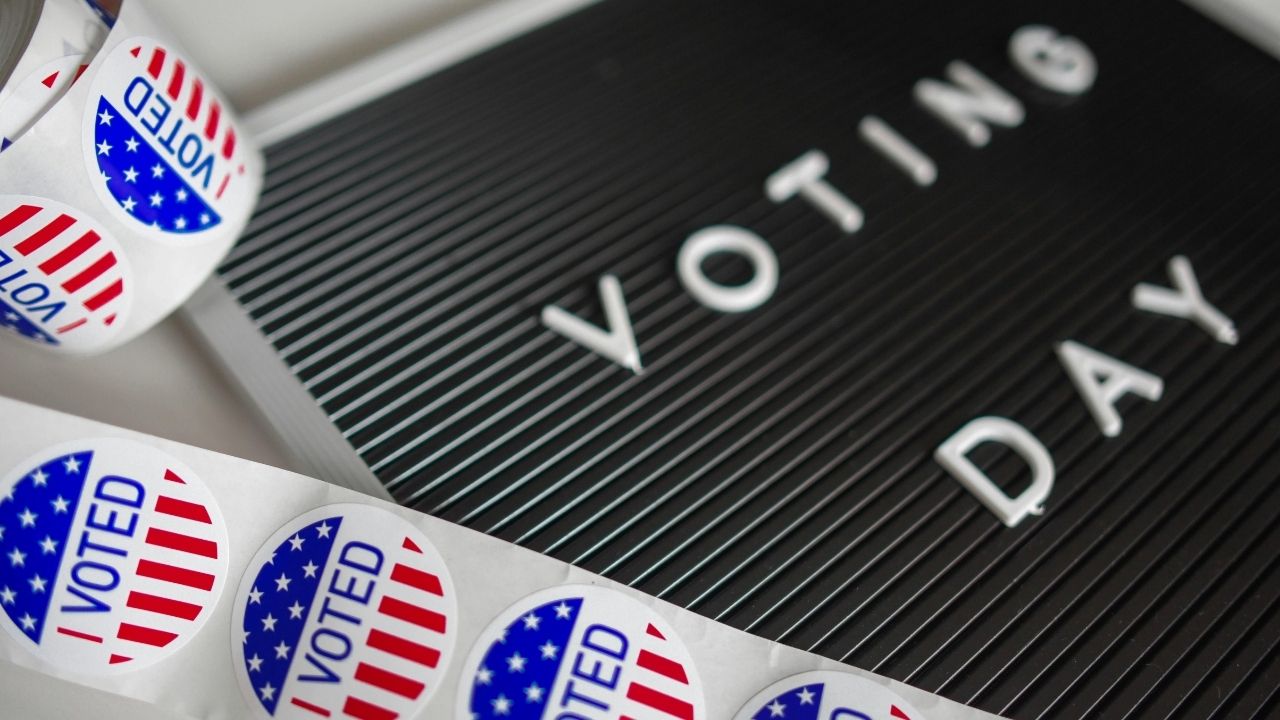 Voting day written on a board with promotional materials next to it.