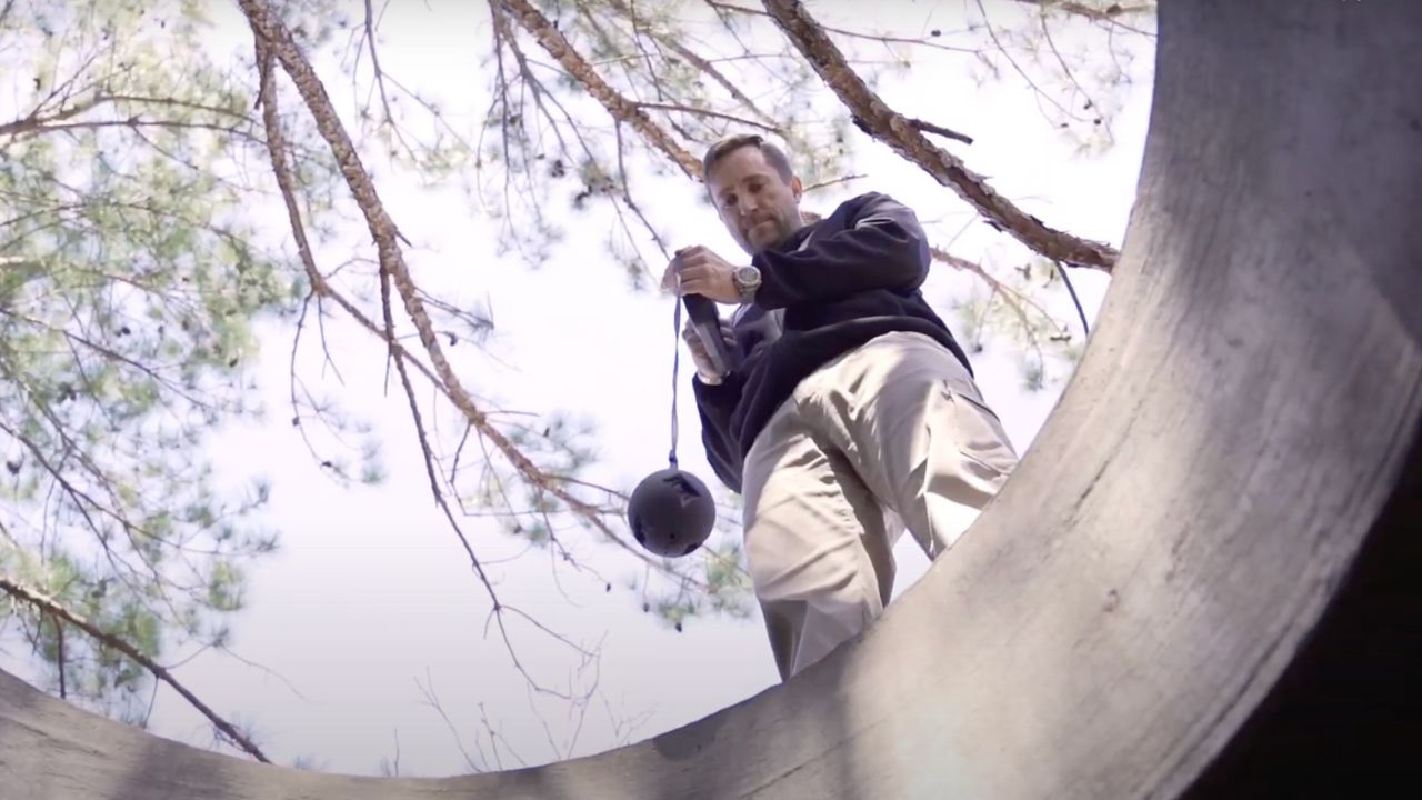 A man using a throwable tactical camera to survey situation 