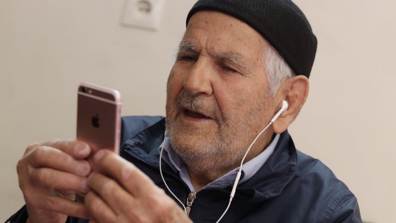 Man in Black Knit Cap Holding Iphone 6