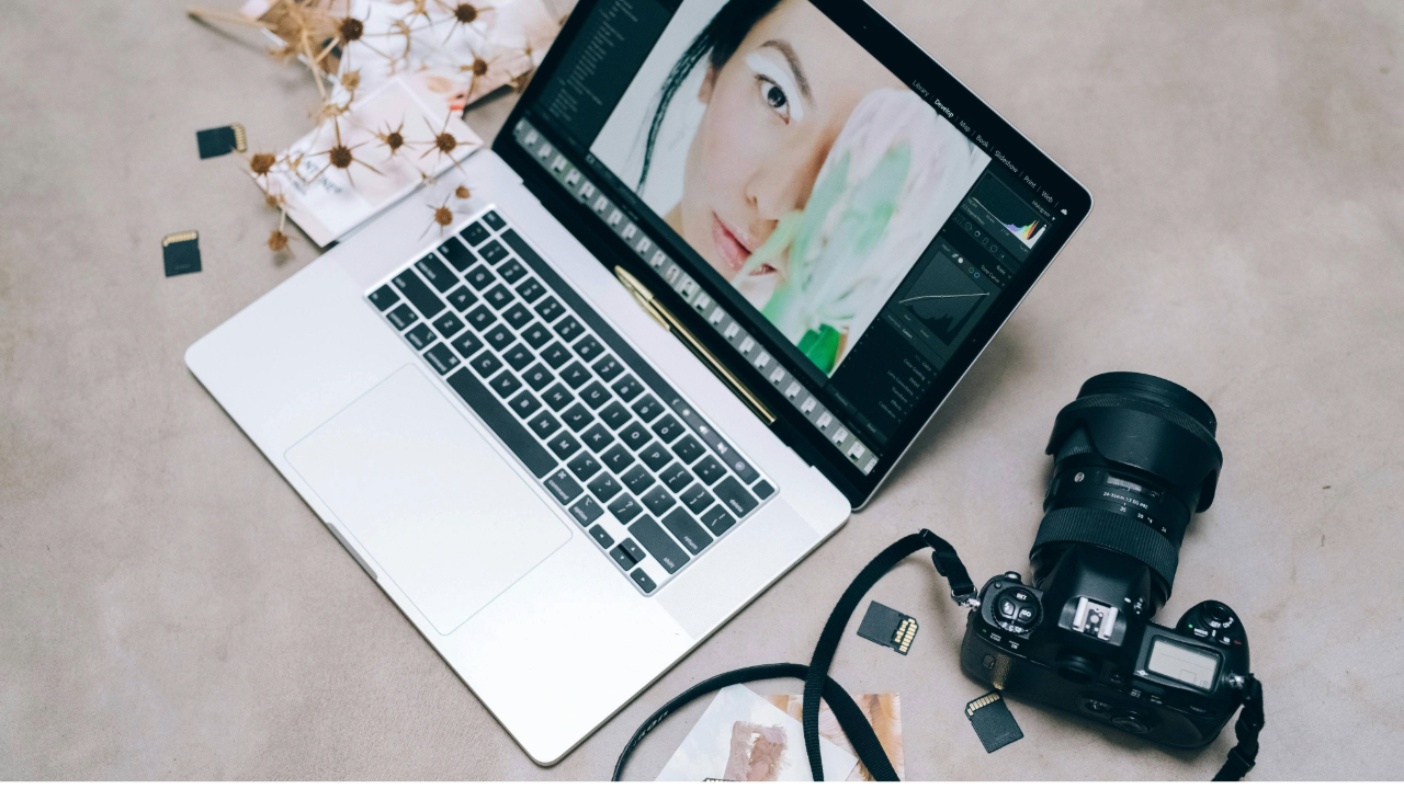 A stock photo showing a laptop, camera, and SD cards.