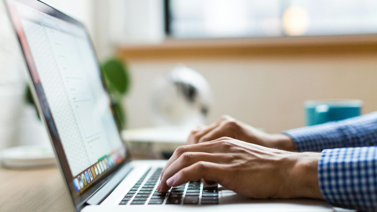 A person typing on laptop