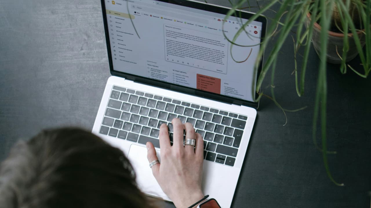 A person typing on a laptop