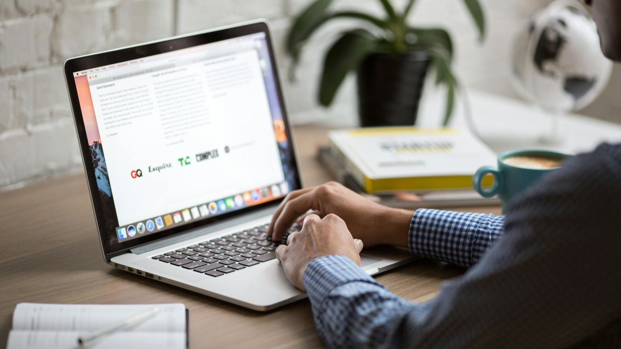 A person typing on a laptop 