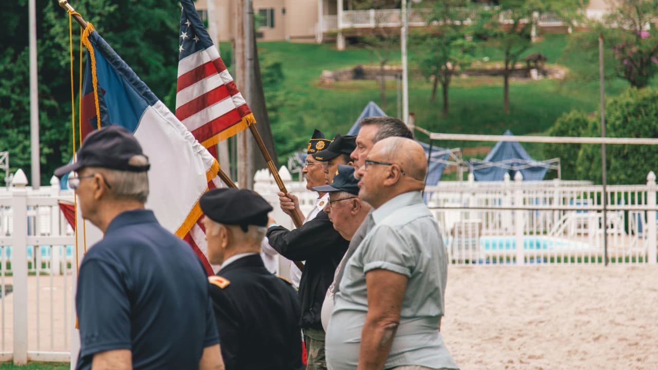 Veterans standing in front of the US flag