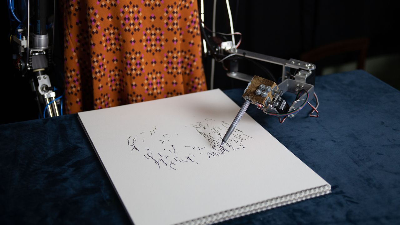 Ai-Da humanoid robot artist creating a piece of art 