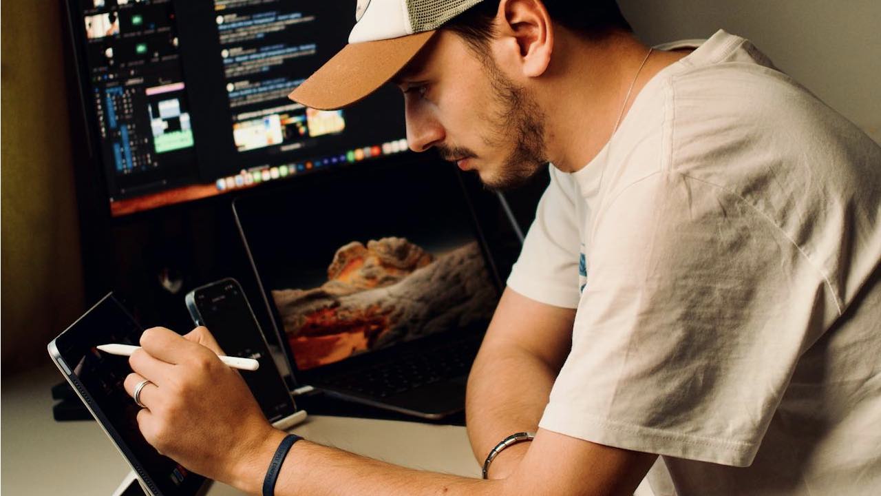 guy in white shirt working on ipad